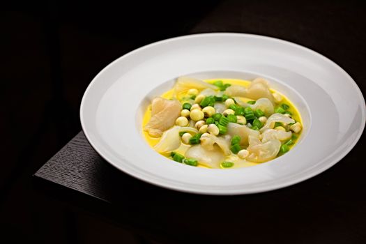 Close-up of a gourmet dish with vibrant colors and fresh ingredients elegantly plated.