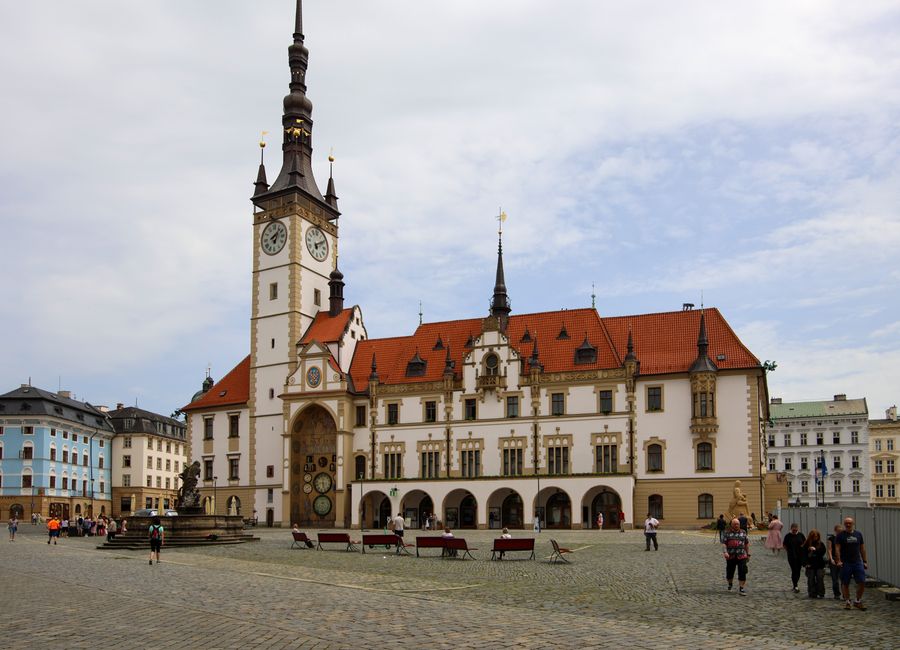 Charming view of the Old Town Hall in Olomouc, Czech Republic, with a lively urban square.