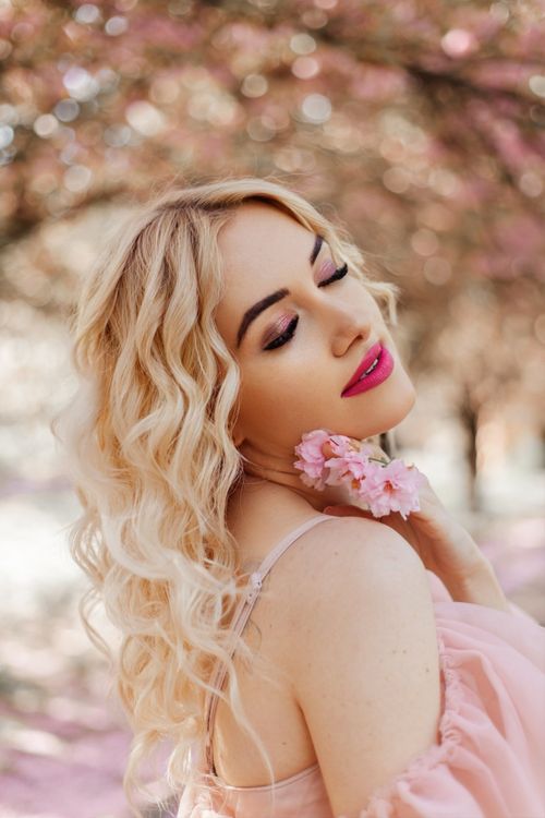Free Elegant woman in pink dress amidst spring blossoms, serene and beautiful. Stock Photo