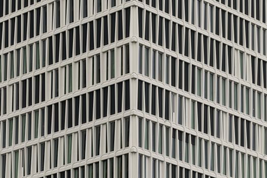 Close-up of a modern office building facade in Frankfurt with geometric window patterns.