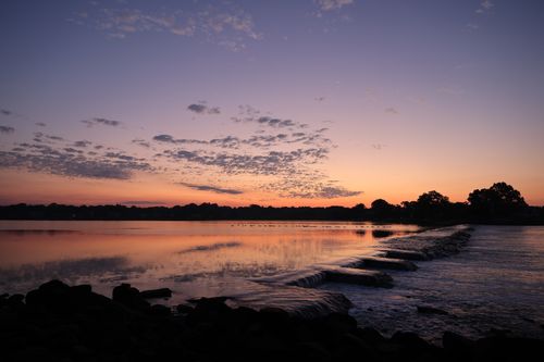 Free A tranquil sunset scene over water with reflecting clouds in Stamford, CT. Stock Photo