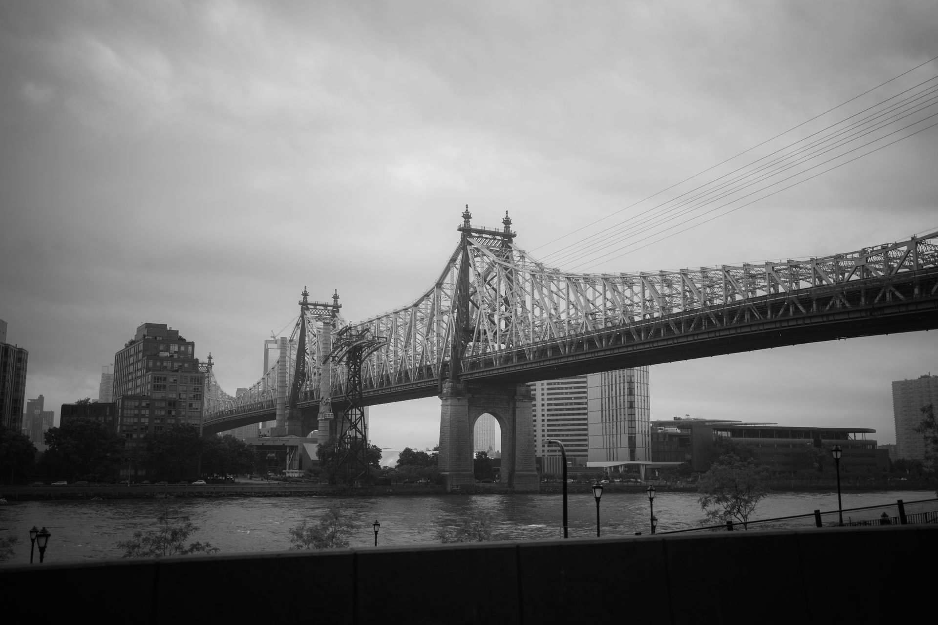 Black and white photo of the iconic Queensboro Bridge crossing the East River in New York City.