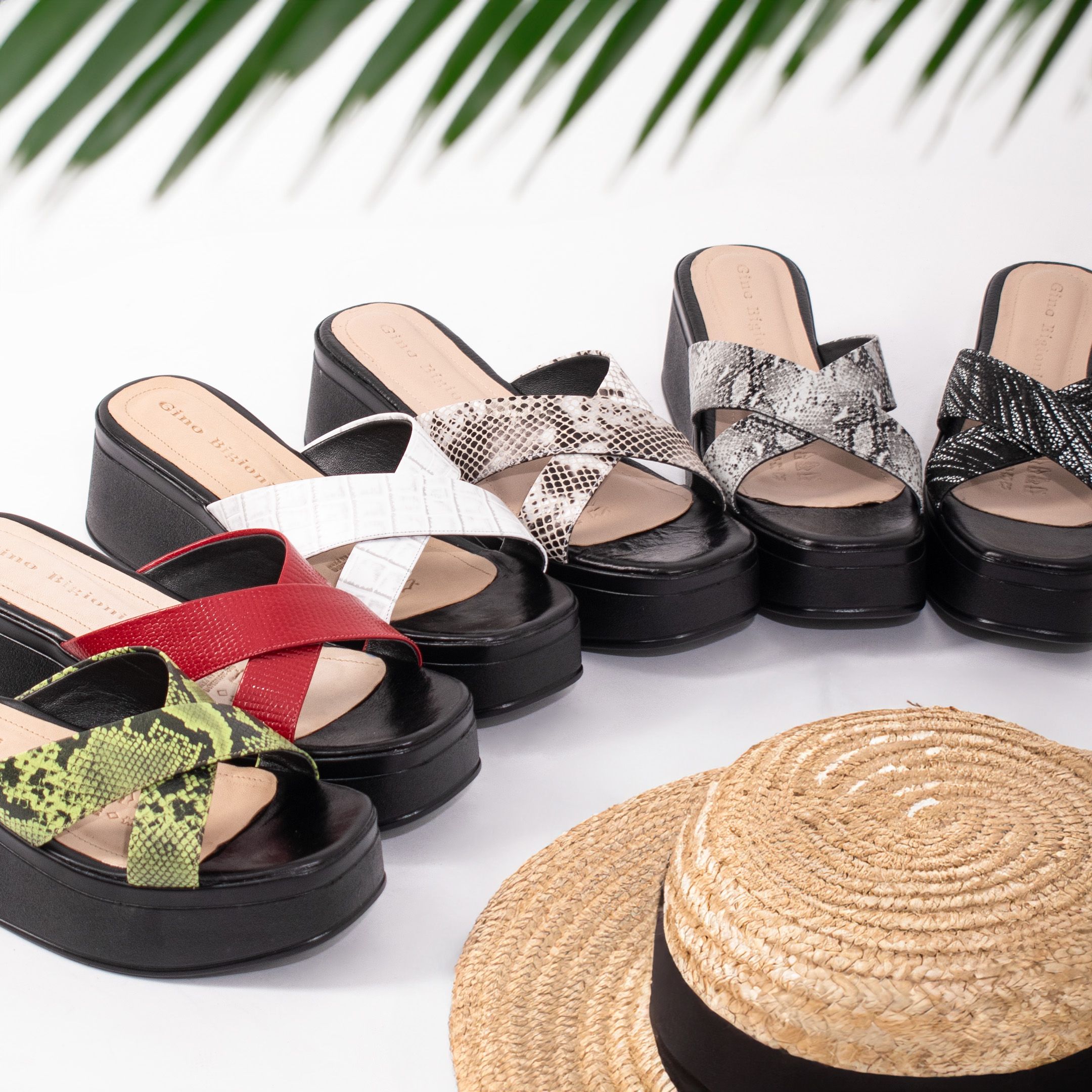 A stylish array of platform sandals in vibrant colors paired with a straw hat. Perfect summer fashion.
