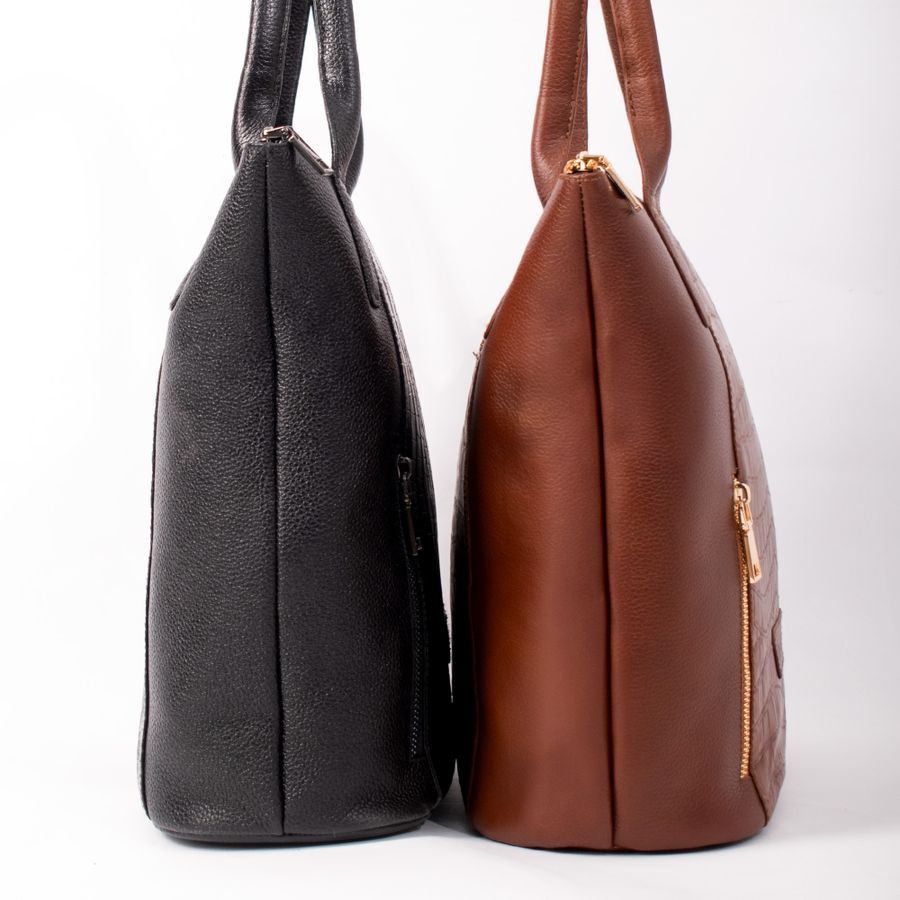 Leather bags photographed together in a studio, hardware catching light