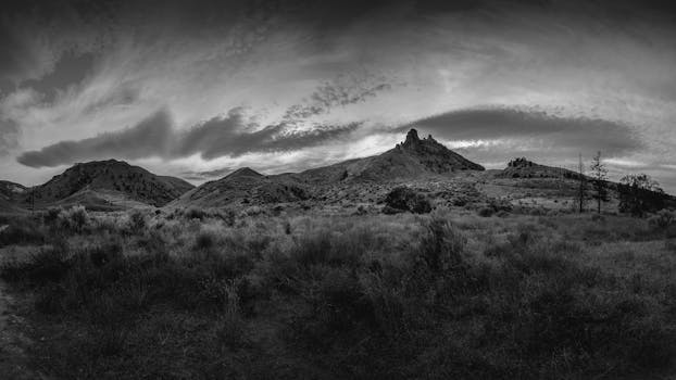 Moody black and white landscape of Wenatchee hills and clouds.