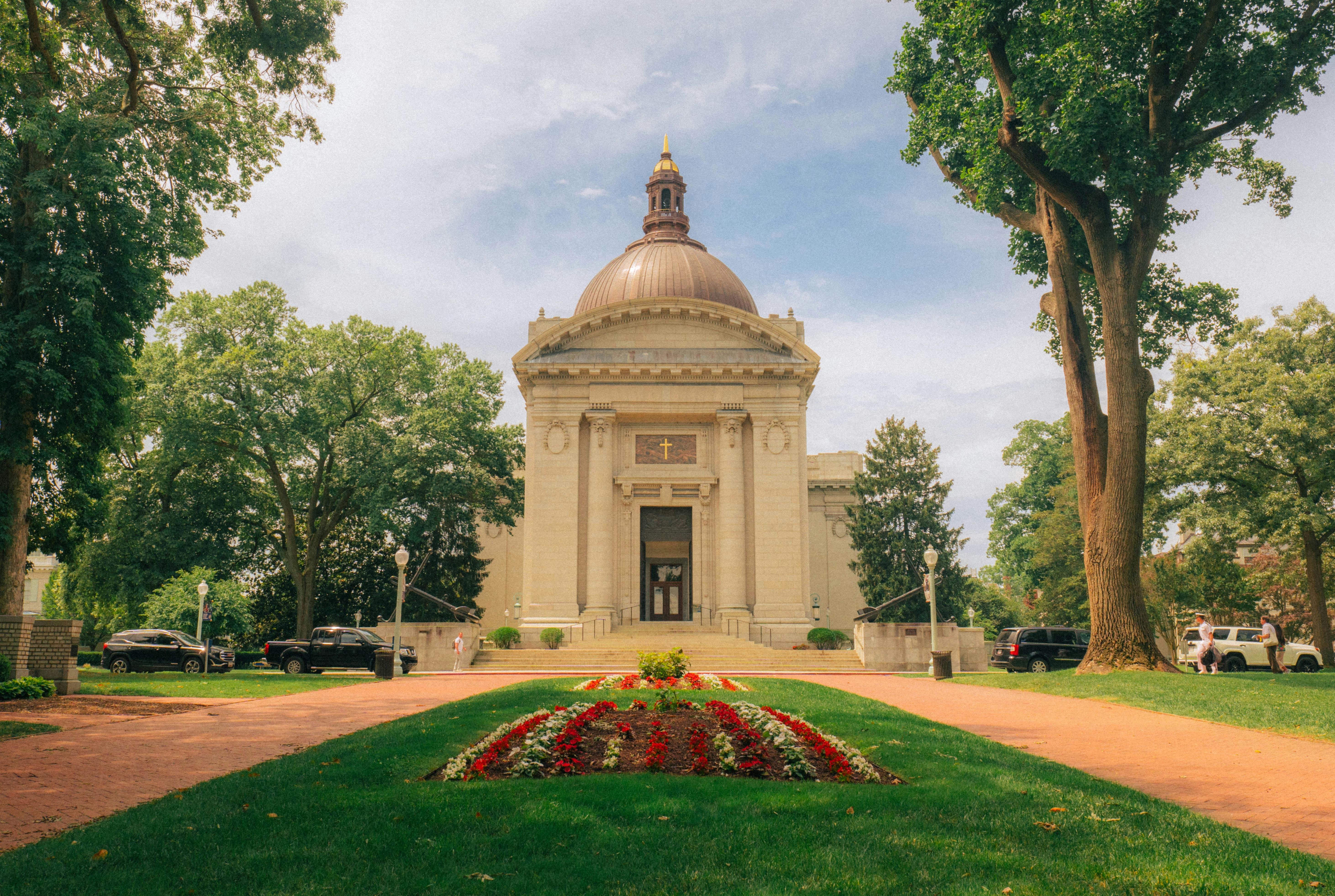 Stunning view of the Naval Academy Chapel surrounded by lush greenery in Annapolis, MD.