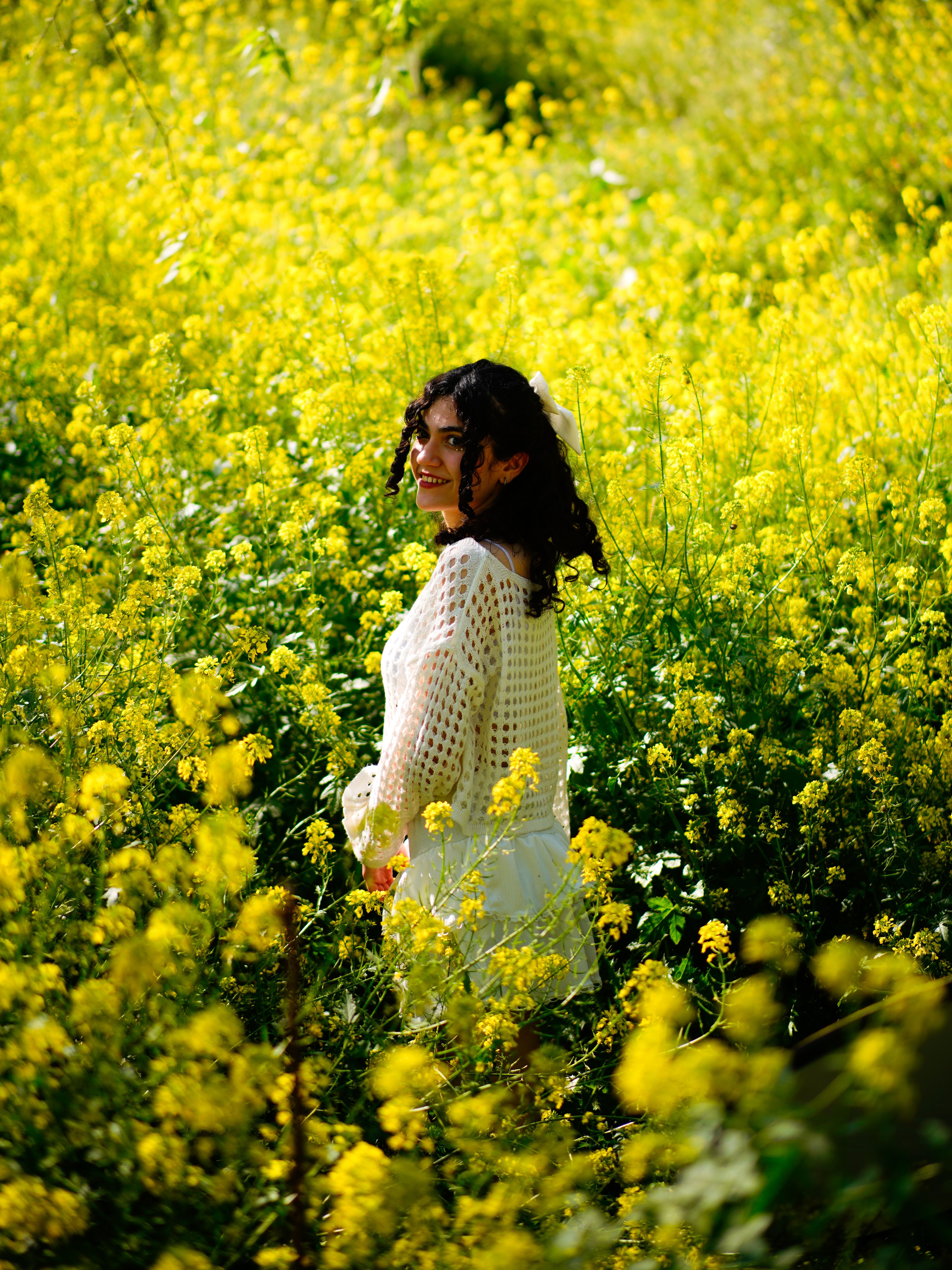 Portrait of Young Woman With Yellow Flowers in Field · Free Stock Photo