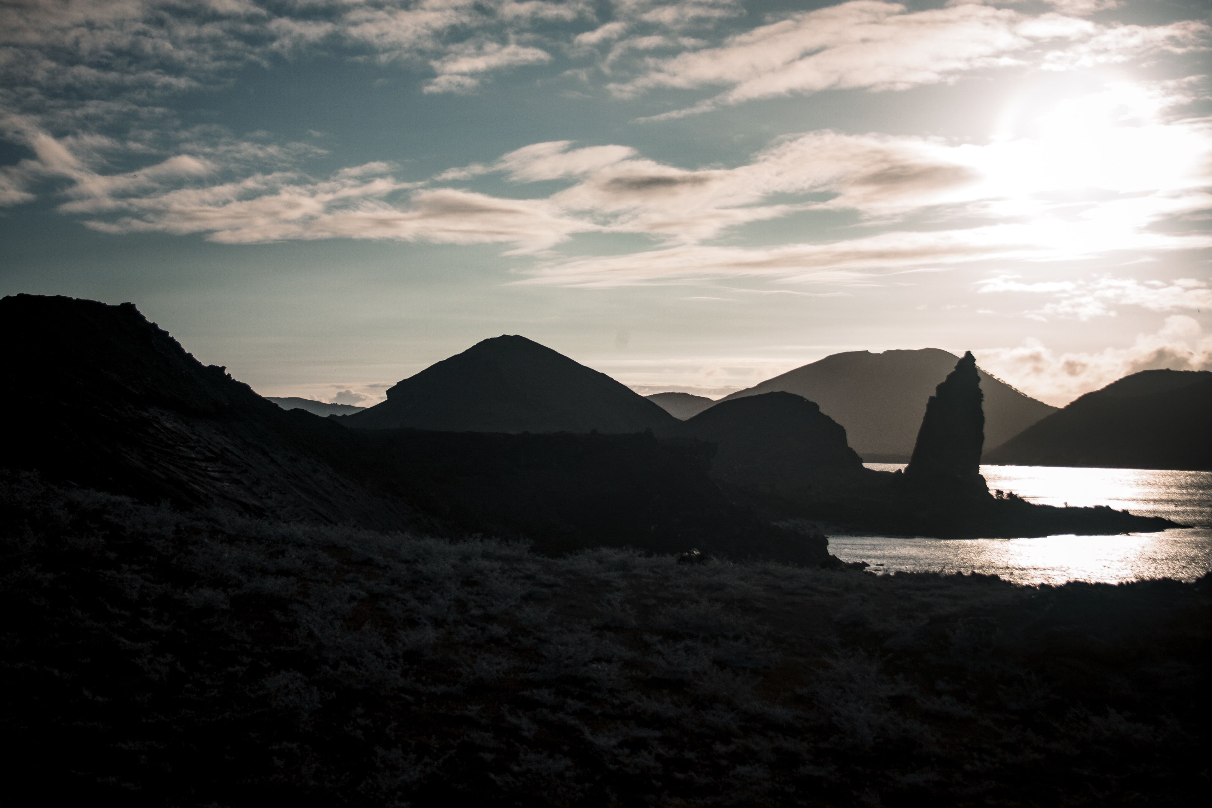 A dramatic view of Pinnacle Rock at sunset with rugged landscapes in the Galapagos Islands.