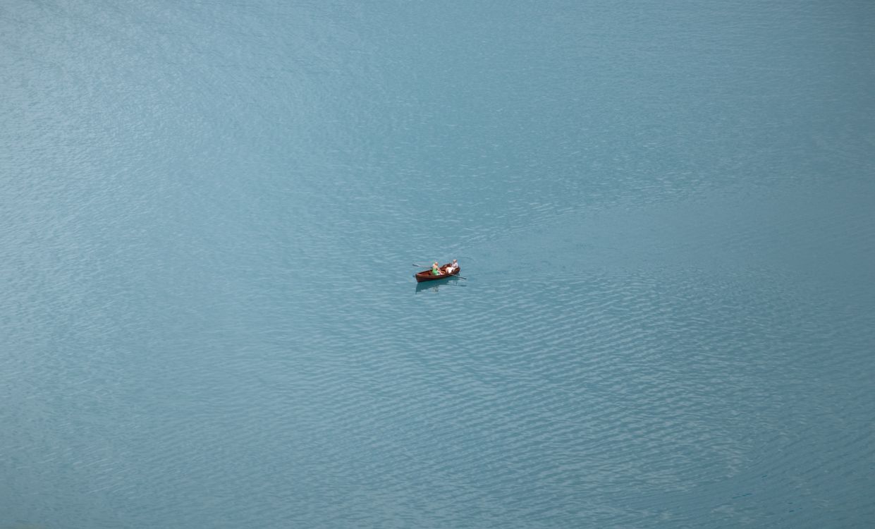 Rowboat From Rear Aerial View of People in a Rowboat on a Lake · Free Stock Photo