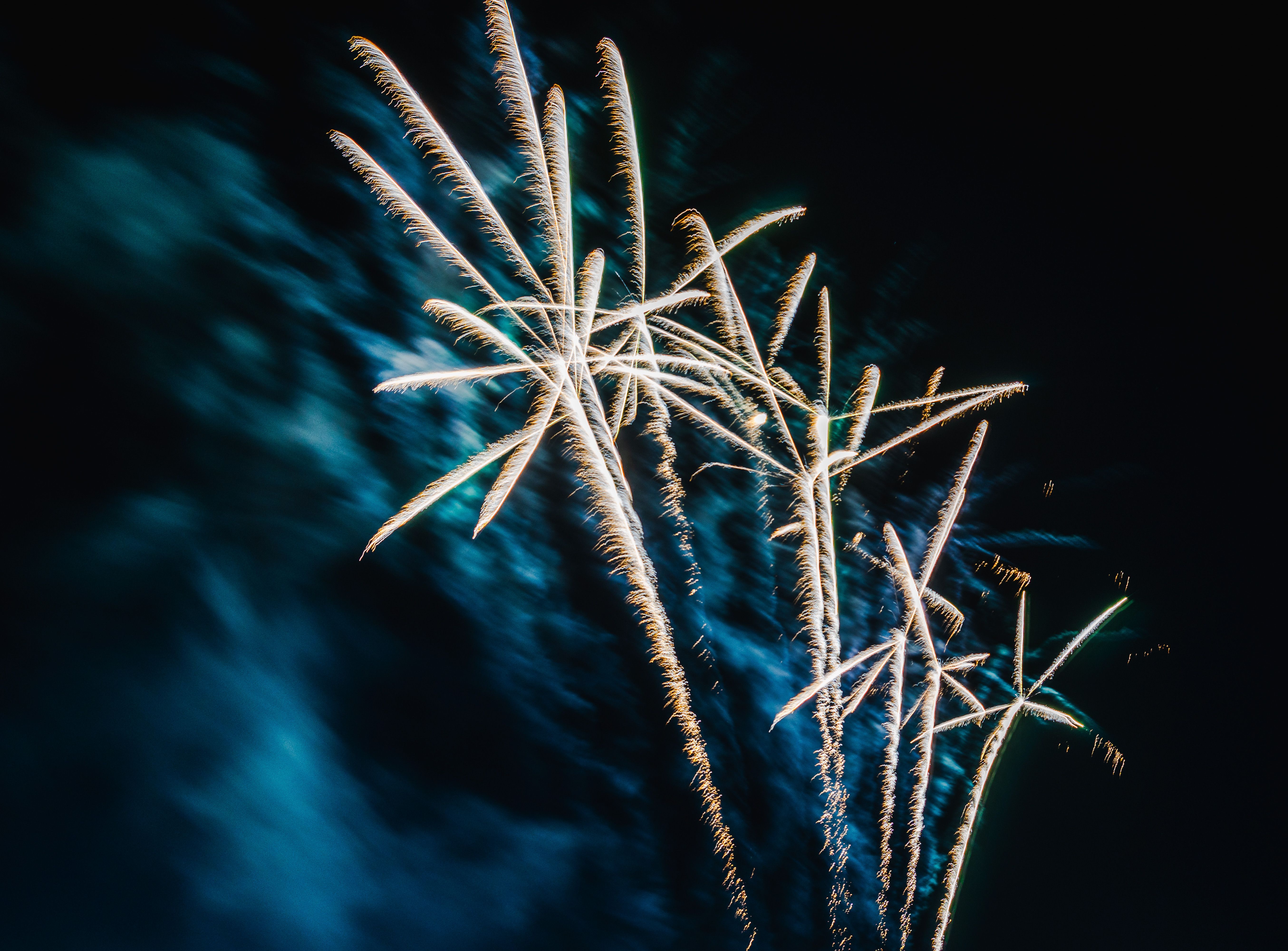 Bright fireworks exploding against a dark night sky, creating a stunning visual spectacle.