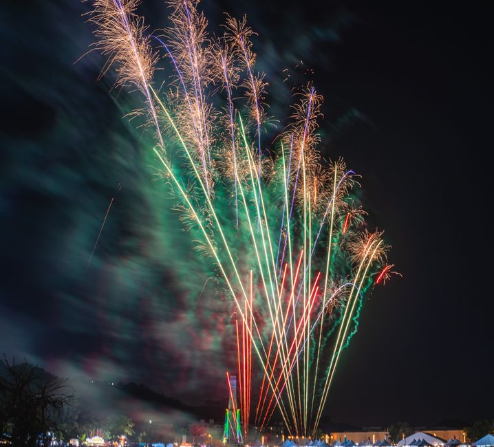 Colorful fireworks illuminating the night sky during a festive celebration.