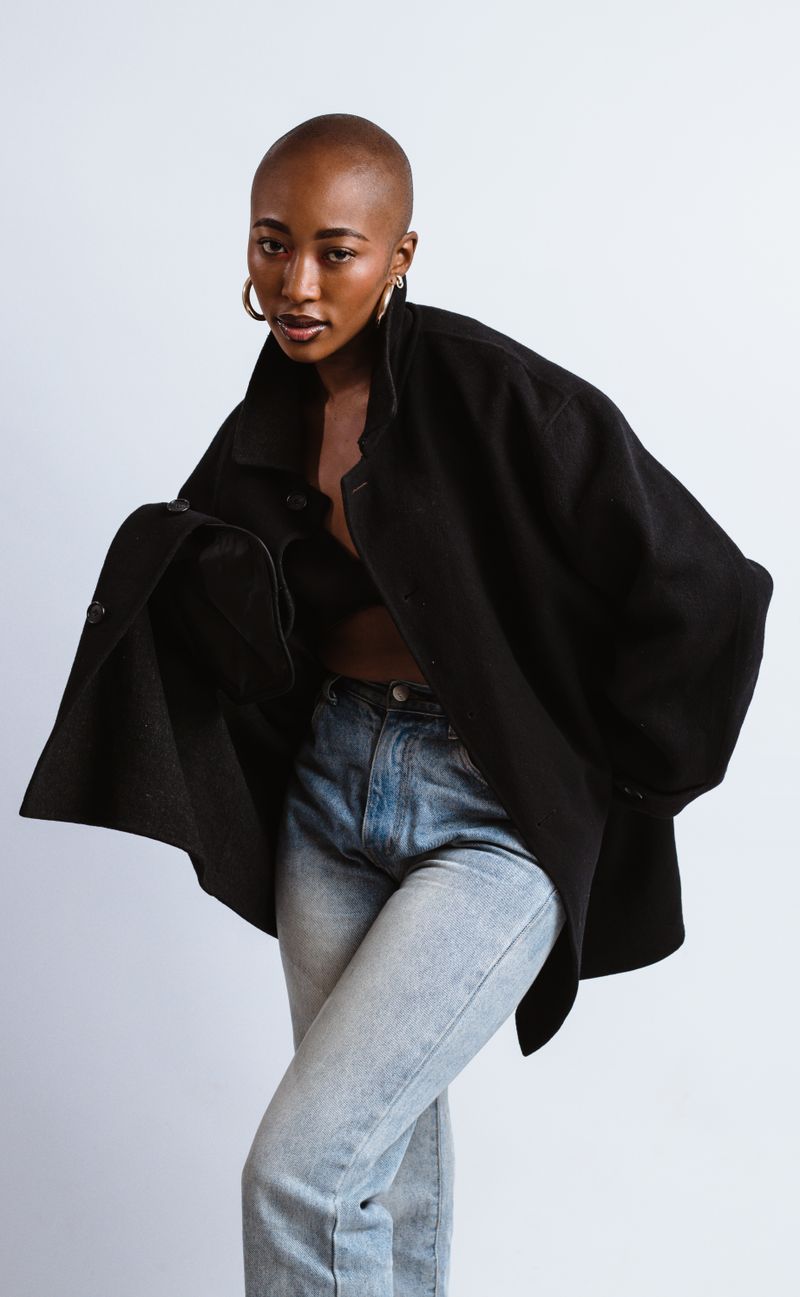 Woman in black coat and jeans