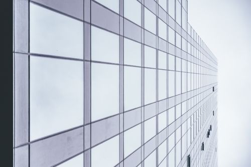 Free Low angle view of a modern glass skyscraper reflecting the sky in Seattle. Stock Photo
