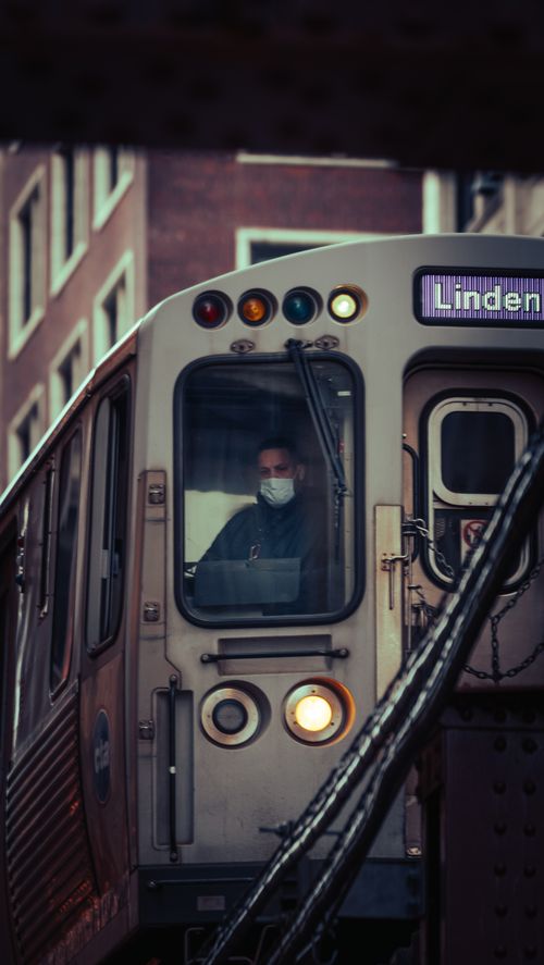 Free Public transportation in Chicago with masked passenger amidst urban background. Stock Photo