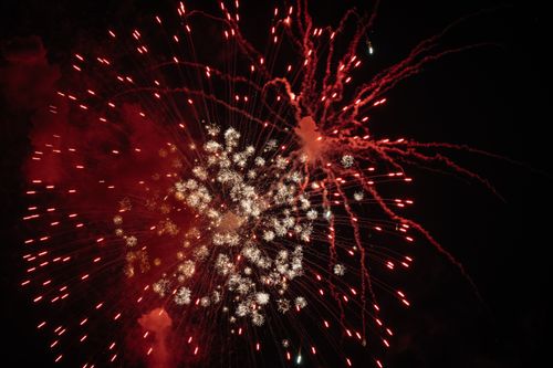 Free A dazzling display of red fireworks lights up the night sky, perfect for celebrations and holidays. Stock Photo