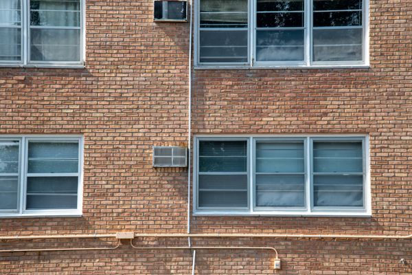 Brick apartment block window bays — photo by Andrew Patrick Photo on Pexels