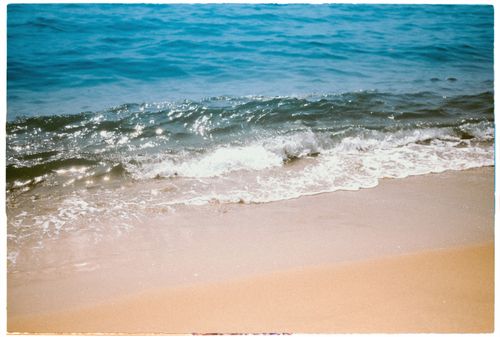 Free Gentle waves lapping at the sandy shore of Da Nang's serene beach. Stock Photo