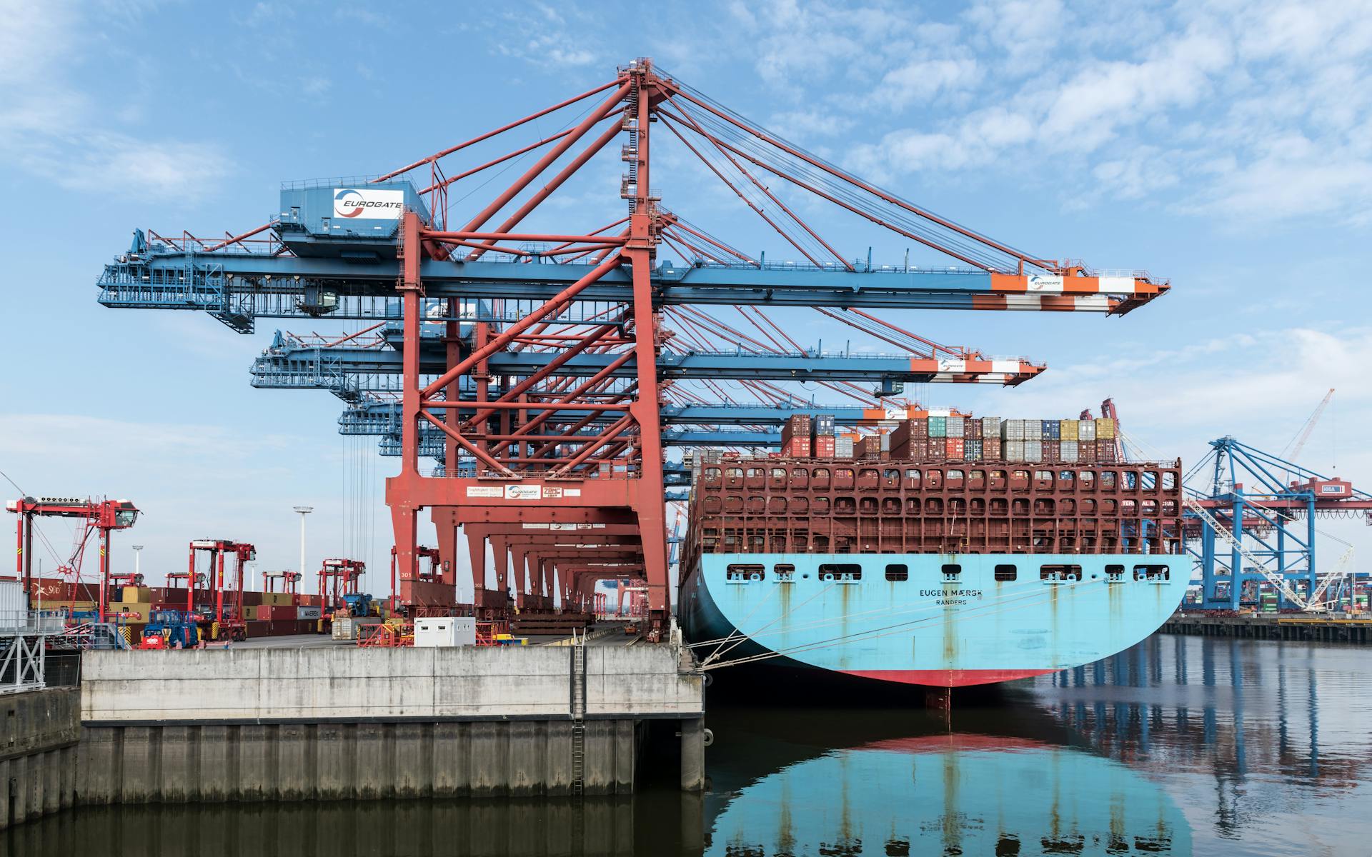 Dockside view of a container ship being loaded at Hamburg harbor.