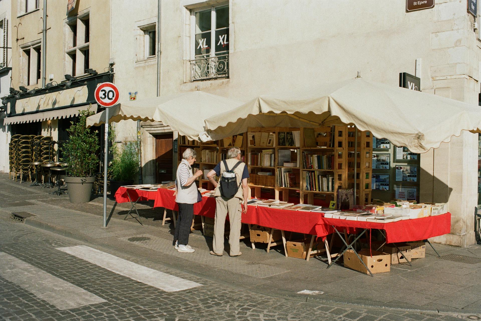 Customers Buying Books at a Flea Market Stall