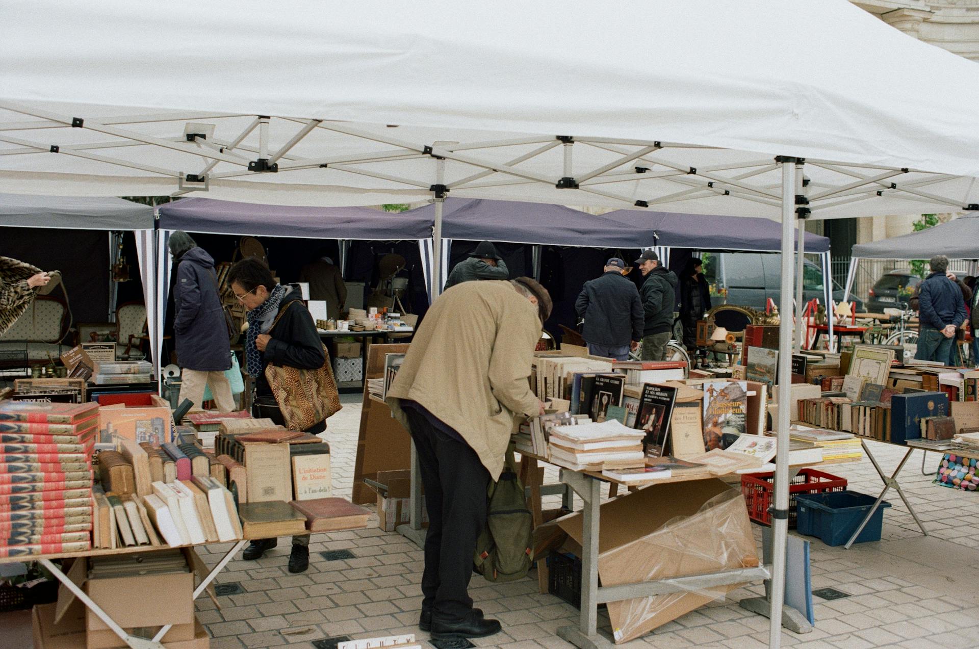 Customers Browsing through Books at a Flea Market