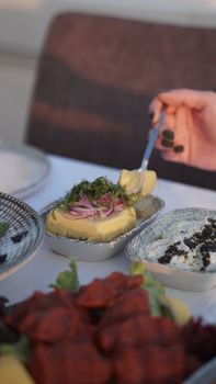 Close-up of a traditional Turkish breakfast setting with butter and herbs in Çanakkale.