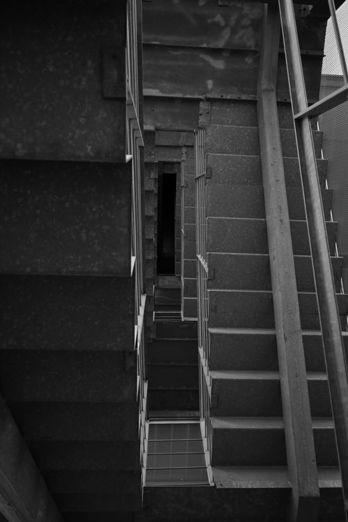 Free Geometric black and white view of an industrial metal staircase. Stock Photo