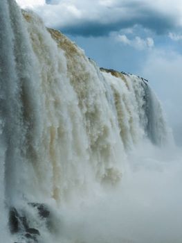 Spectacular view of a waterfall cascading with force, evoking a sense of natural wonder.