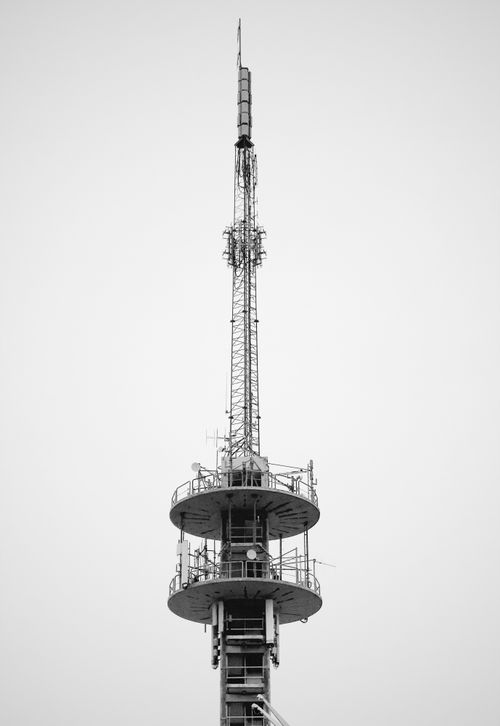 Free Monochrome image of a towering industrial communication structure against the sky. Stock Photo