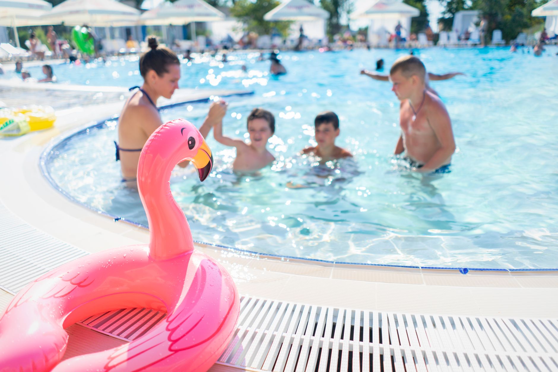 funday inflatables and games egypt — Children having fun and playing in an outdoor swimming pool on a bright summer day.