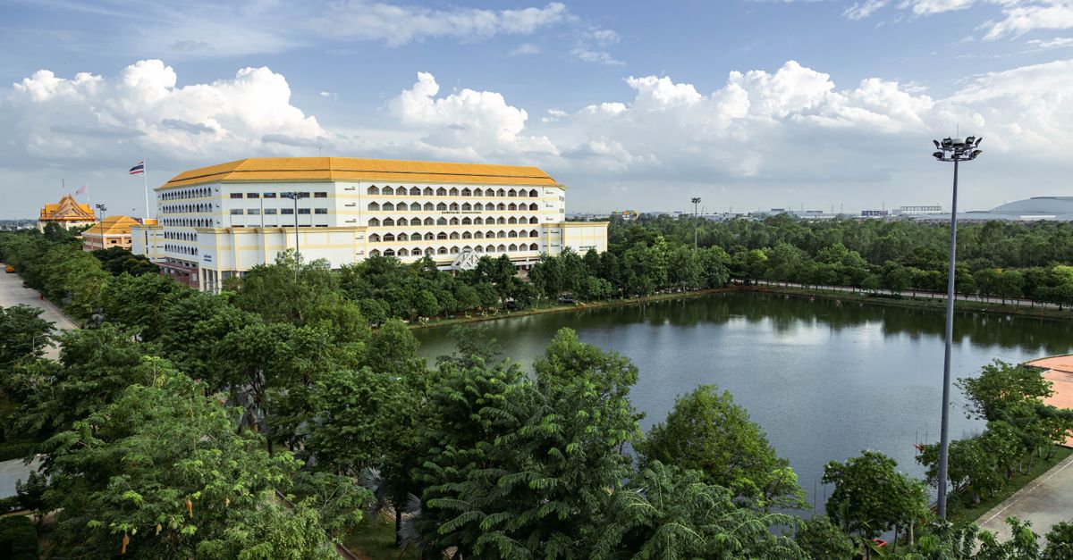 Aerial view of a large building with a pond and trees in Ayutthaya, Thailand.
