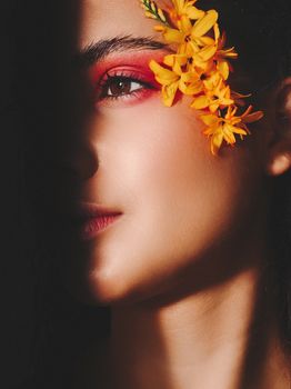 Creative portrait featuring colorful floral makeup with a vibrant and elegant vibe.