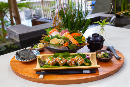 Free A vibrant sushi platter with an assortment of fresh seafood delicacies on a wooden tray. Stock Photo