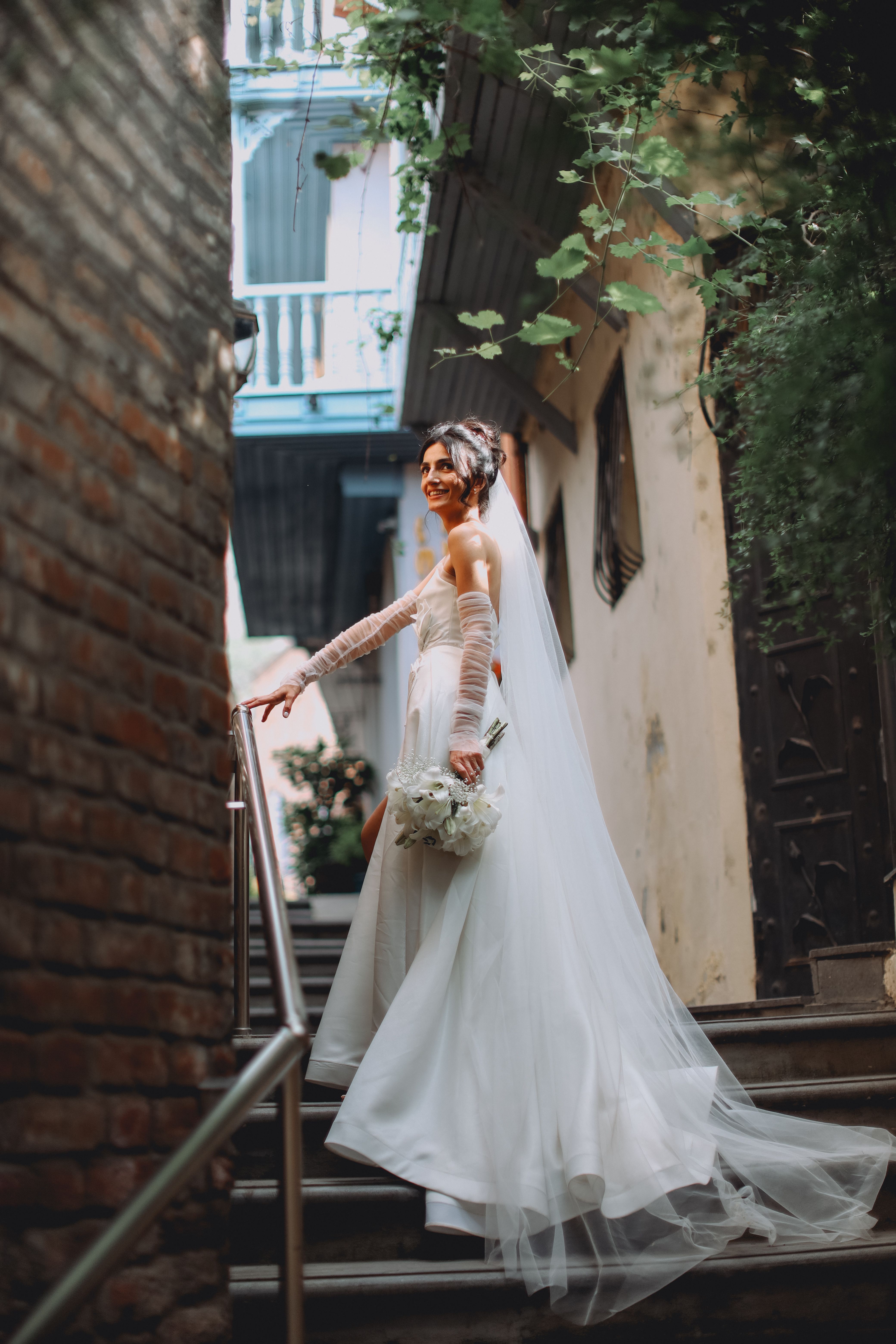 Portrait of a Bride Standing on Steps in the Old Town · Free Stock Photo