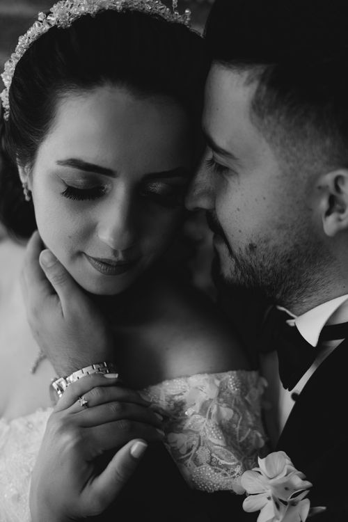 Free Romantic black and white photo of a bride and groom in an intimate embrace on their wedding day. Stock Photo