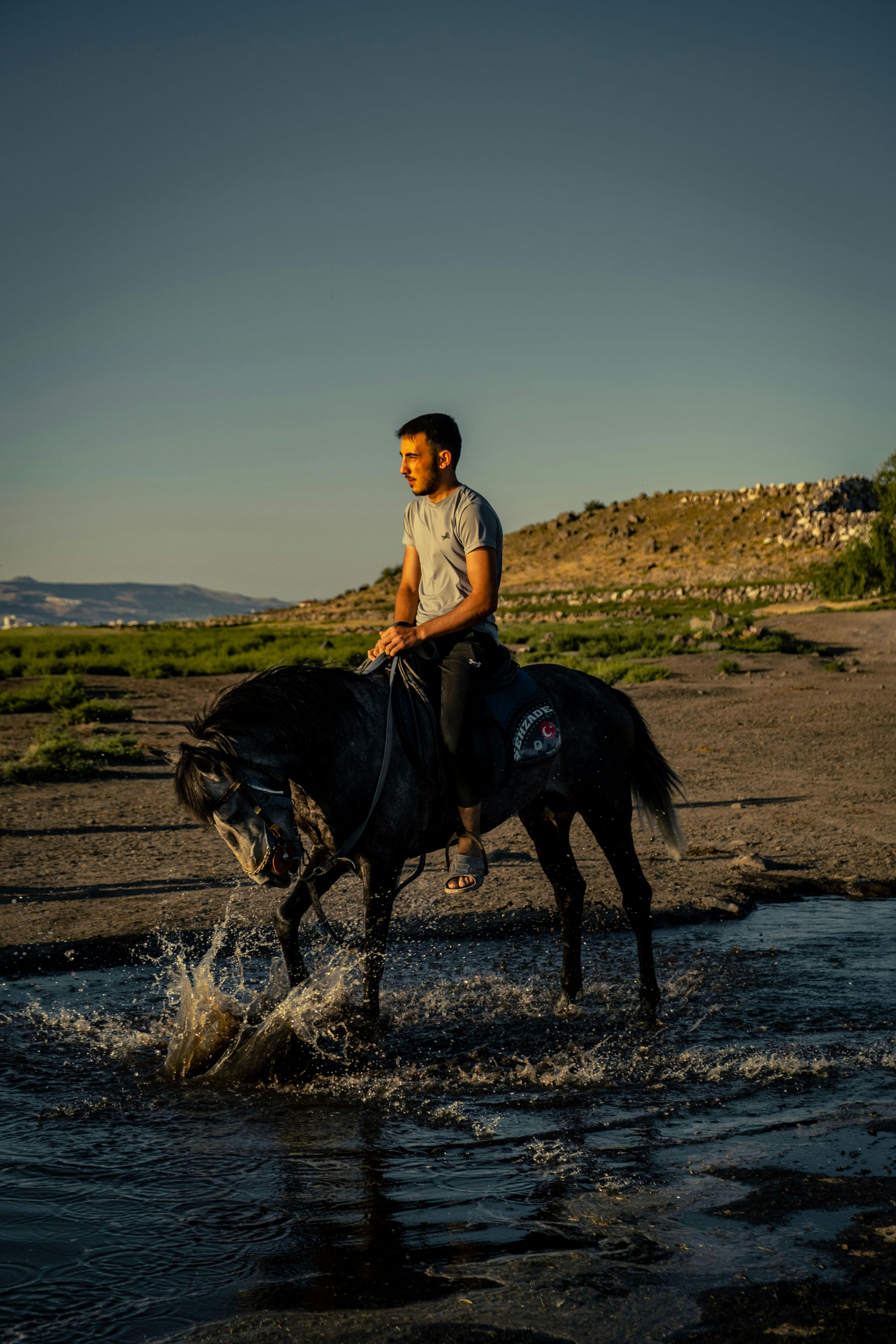 Man Riding a Horse on a Lakeshore