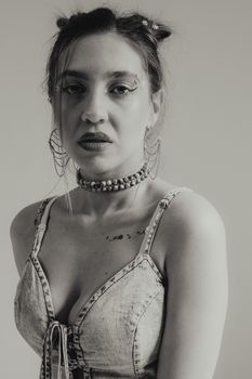 Elegant black and white portrait of a woman posing, showcasing modern fashion.