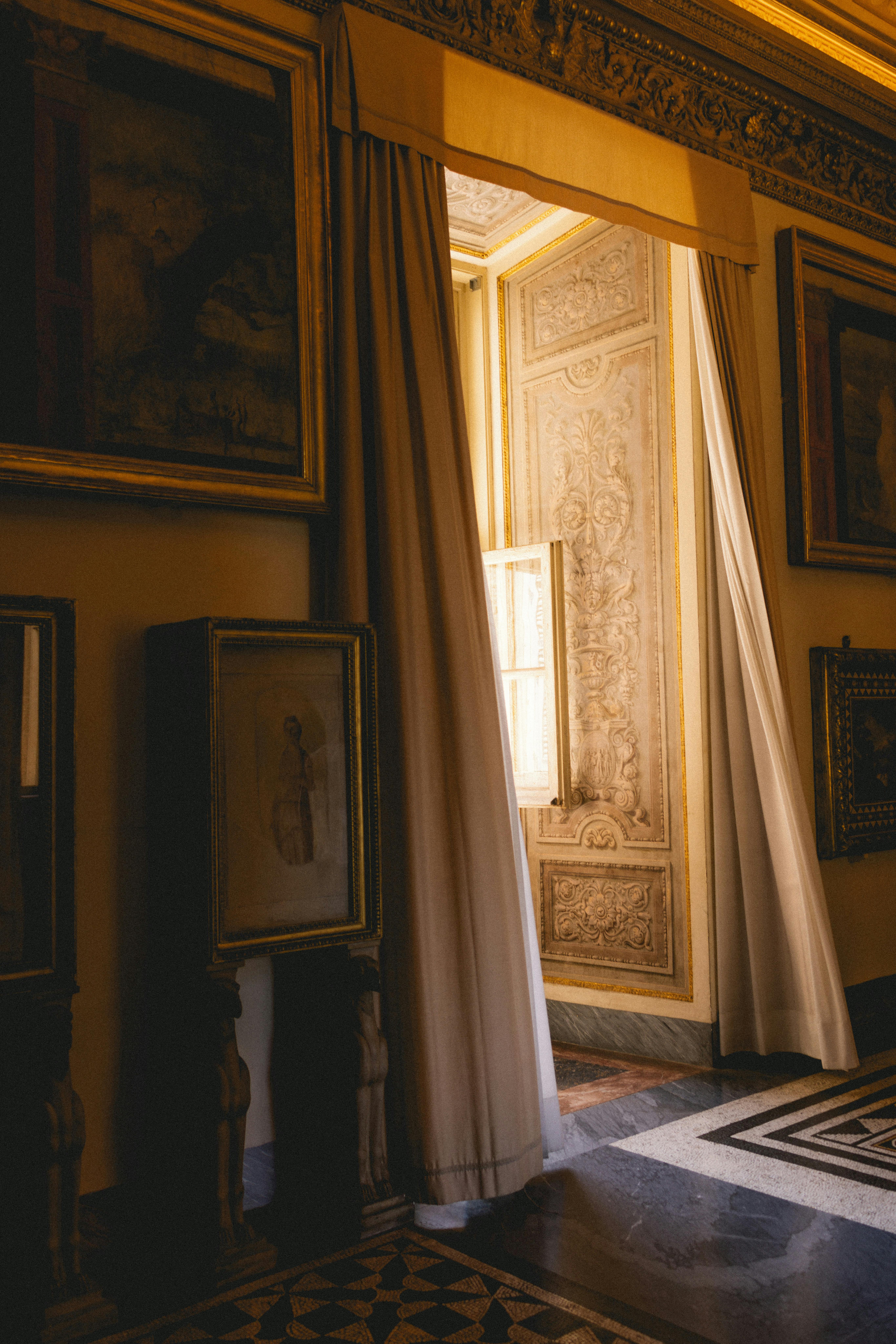 A glimpse through ornate curtains showcasing beautiful interior architecture in Vatican Museums.