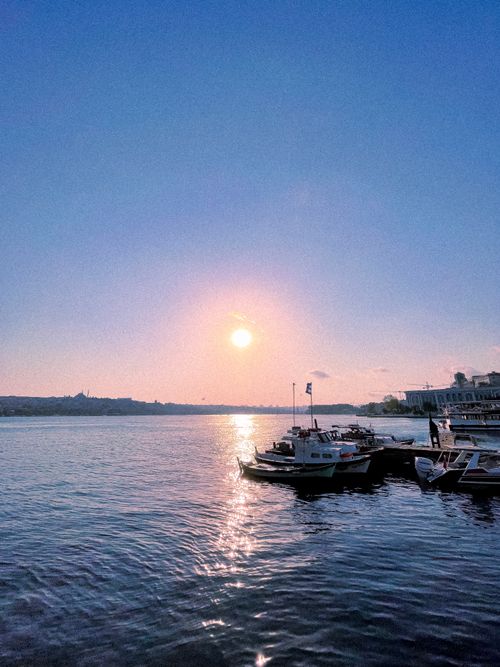 Free Beautiful sunset over the Bosphorus in Istanbul with boats moored at the coast. Stock Photo