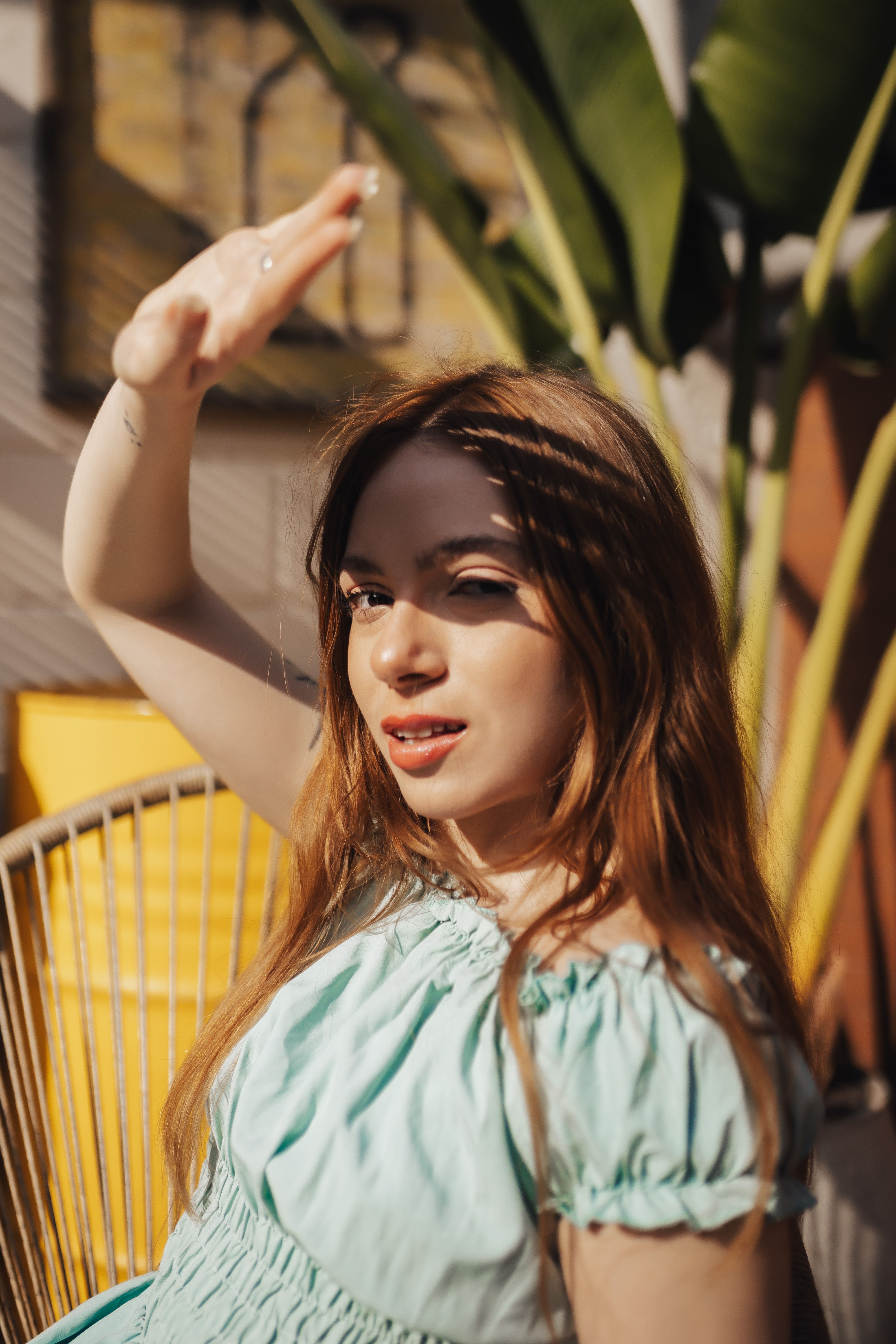 a-woman-in-a-blue-dress-is-holding-her-hand-up-free-stock-photo