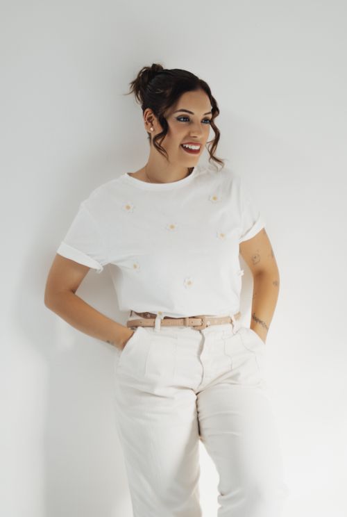 Free Portrait of a smiling woman posing casually in white attire indoors. Stock Photo