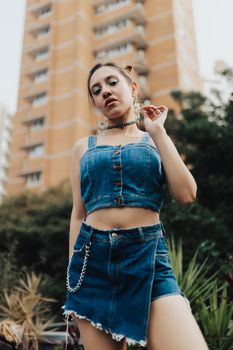 Stylish woman wearing denim in a lively urban environment in São Paulo.