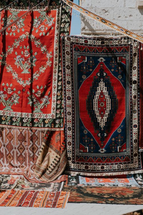 Free Vibrant display of Turkish rugs hung outdoors, showcasing intricate patterns and colors. Stock Photo