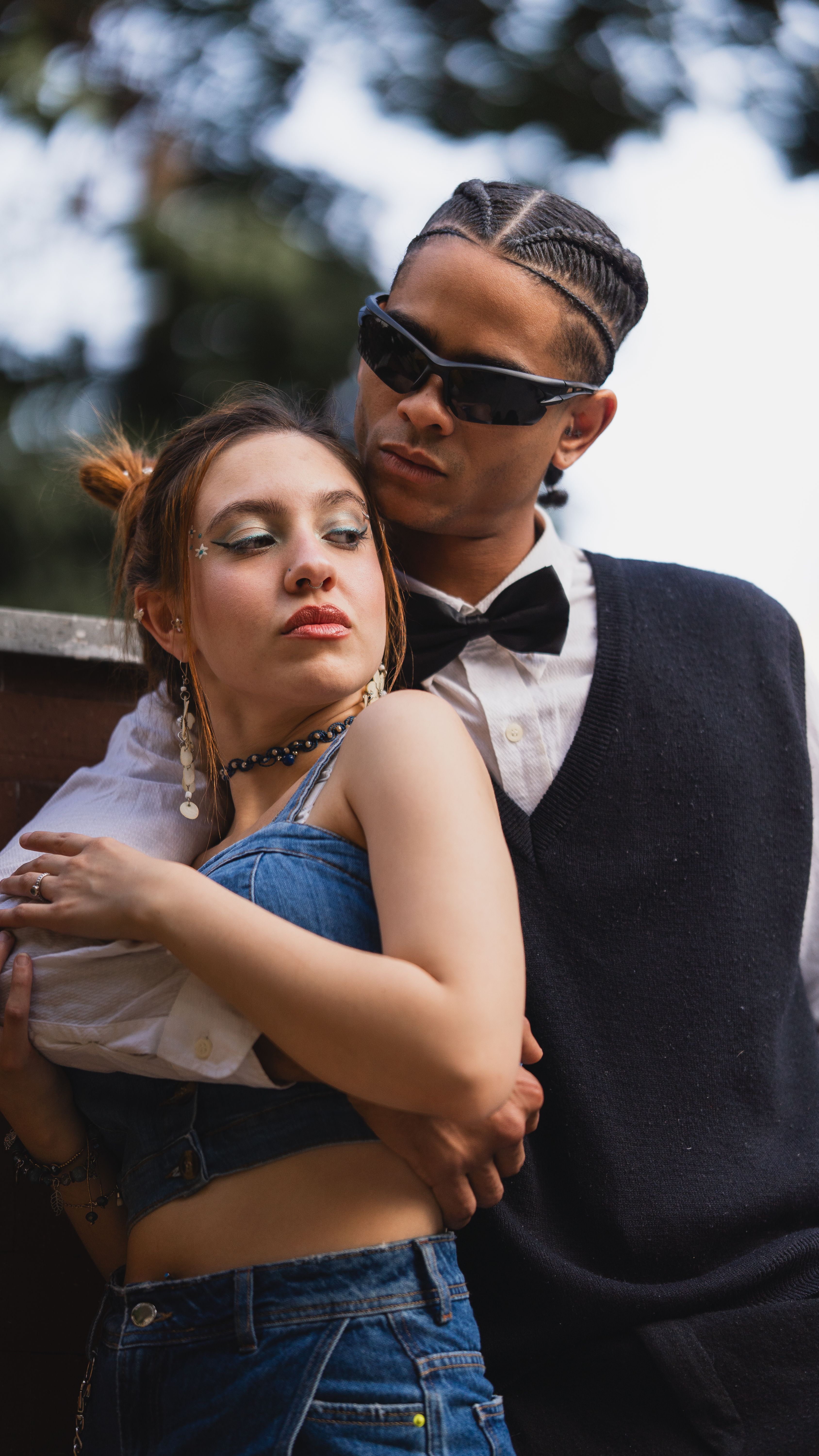 A man and woman in sunglasses hugging · Free Stock Photo