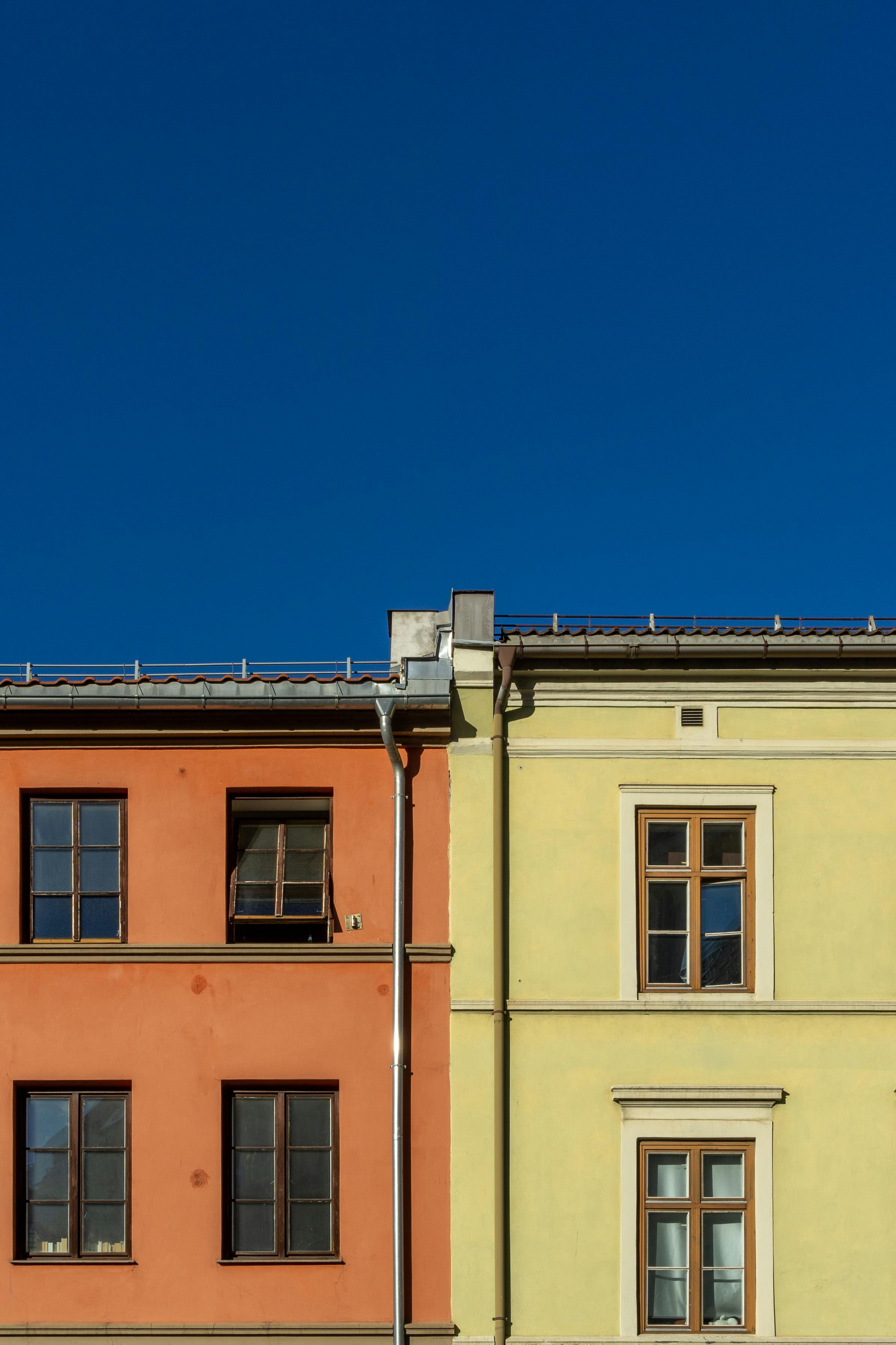 Vibrant urban landscape showcasing colorful building facades and clear blue sky in Oslo, Norway.