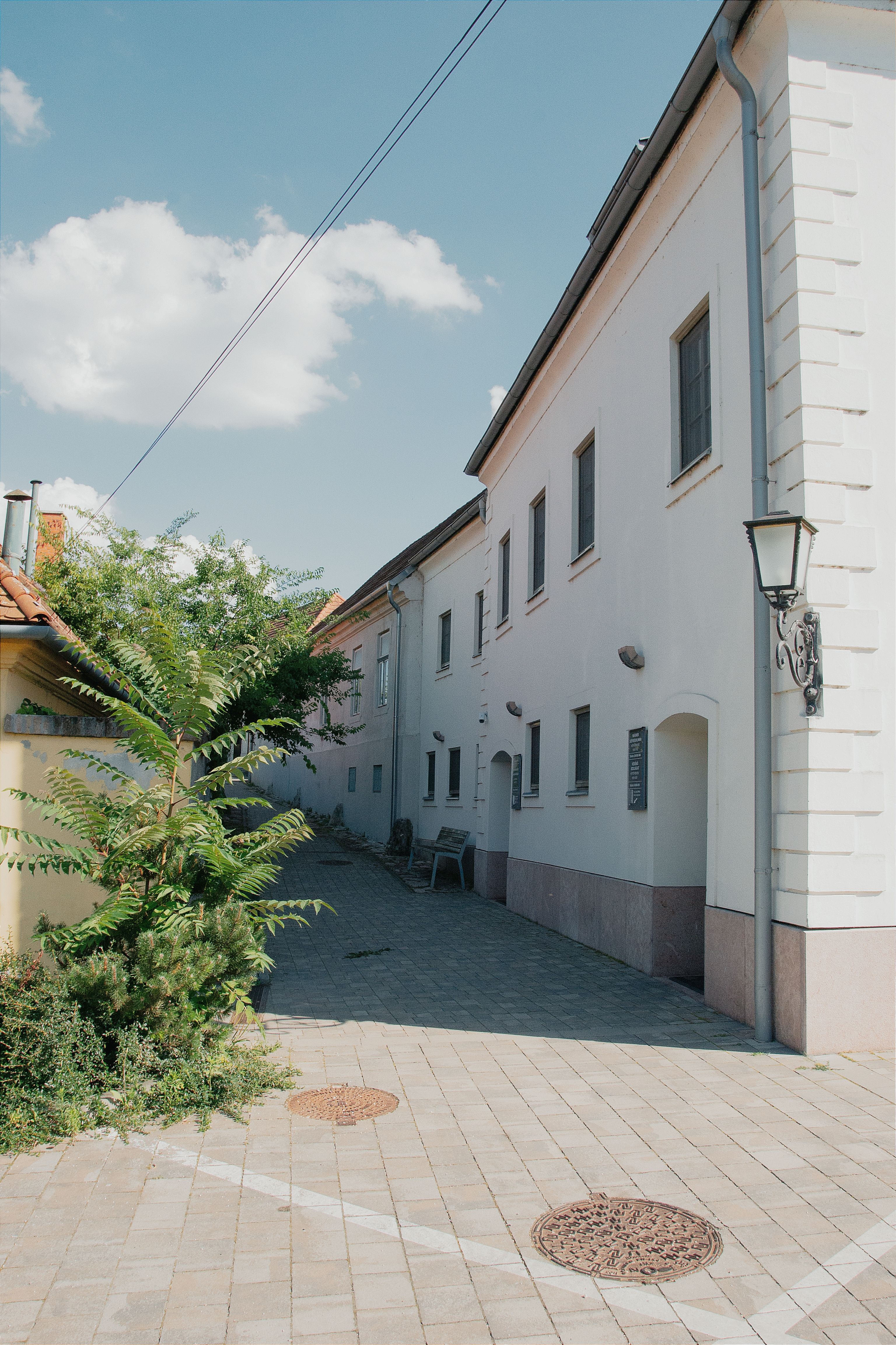 Narrow Pavement Alley between Buildings · Free Stock Photo