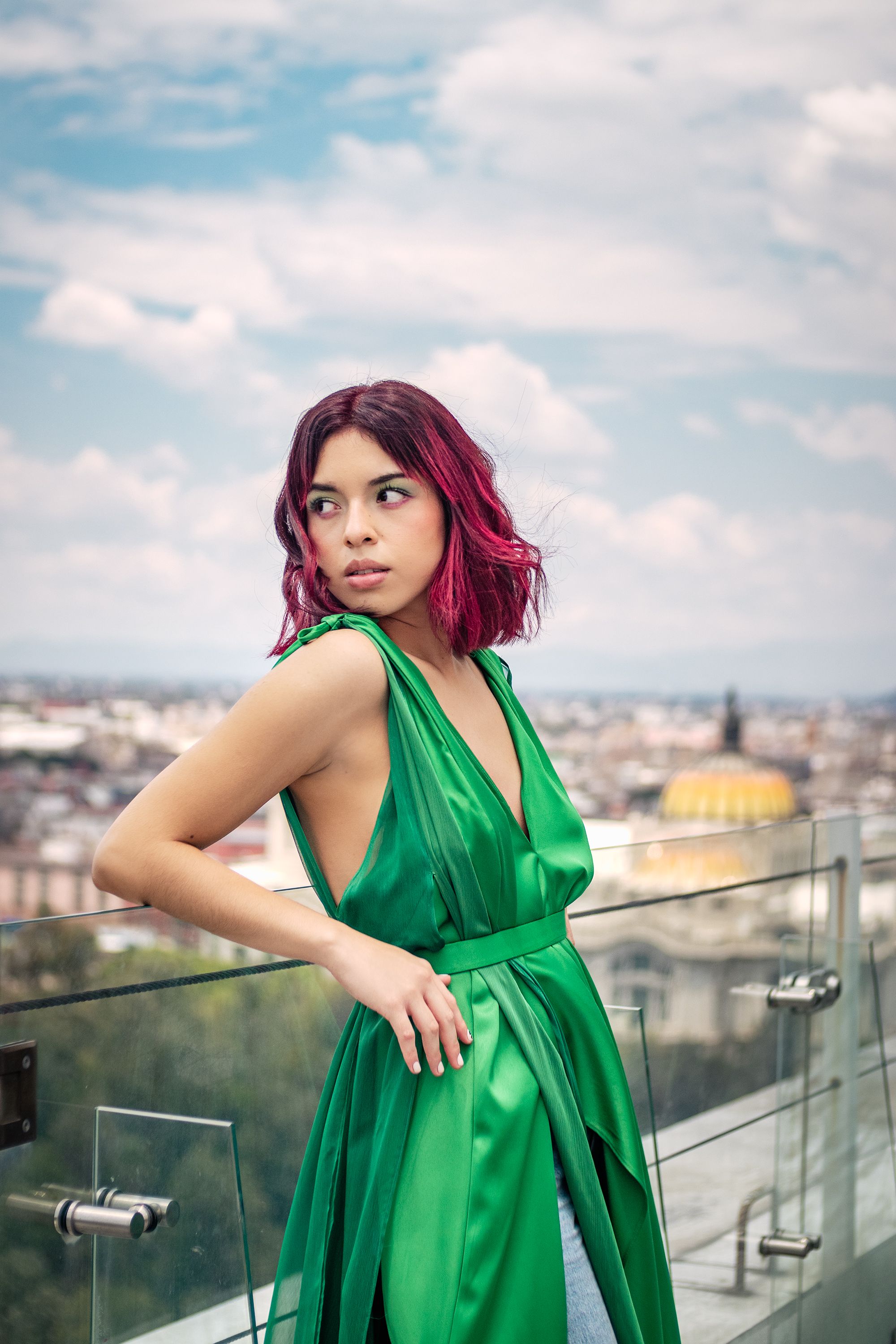 Woman with Dark Pink Hair Posing on Rooftop Wearing Shiny Green Dress   Free Stock Photo