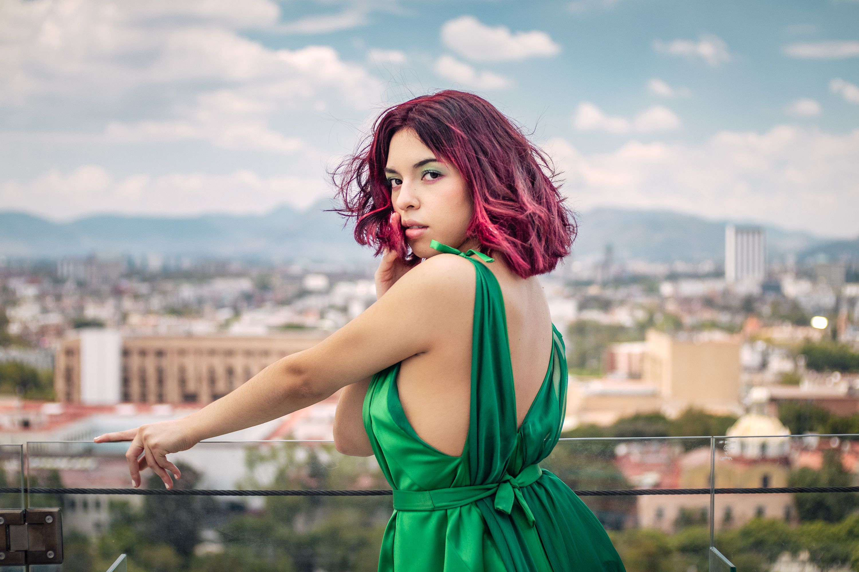 Portrait of Woman with Dark Pink Hair Wearing Shiny Green Dress on Rooftop   Free Stock Photo