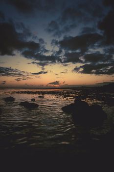 A stunning sunset view over the rocky coastline at Pearl Harbor, Hawaii.