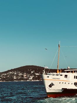 Scenic view of Barış Manço ferry sailing near Adalar, İstanbul with a clear blue sky.