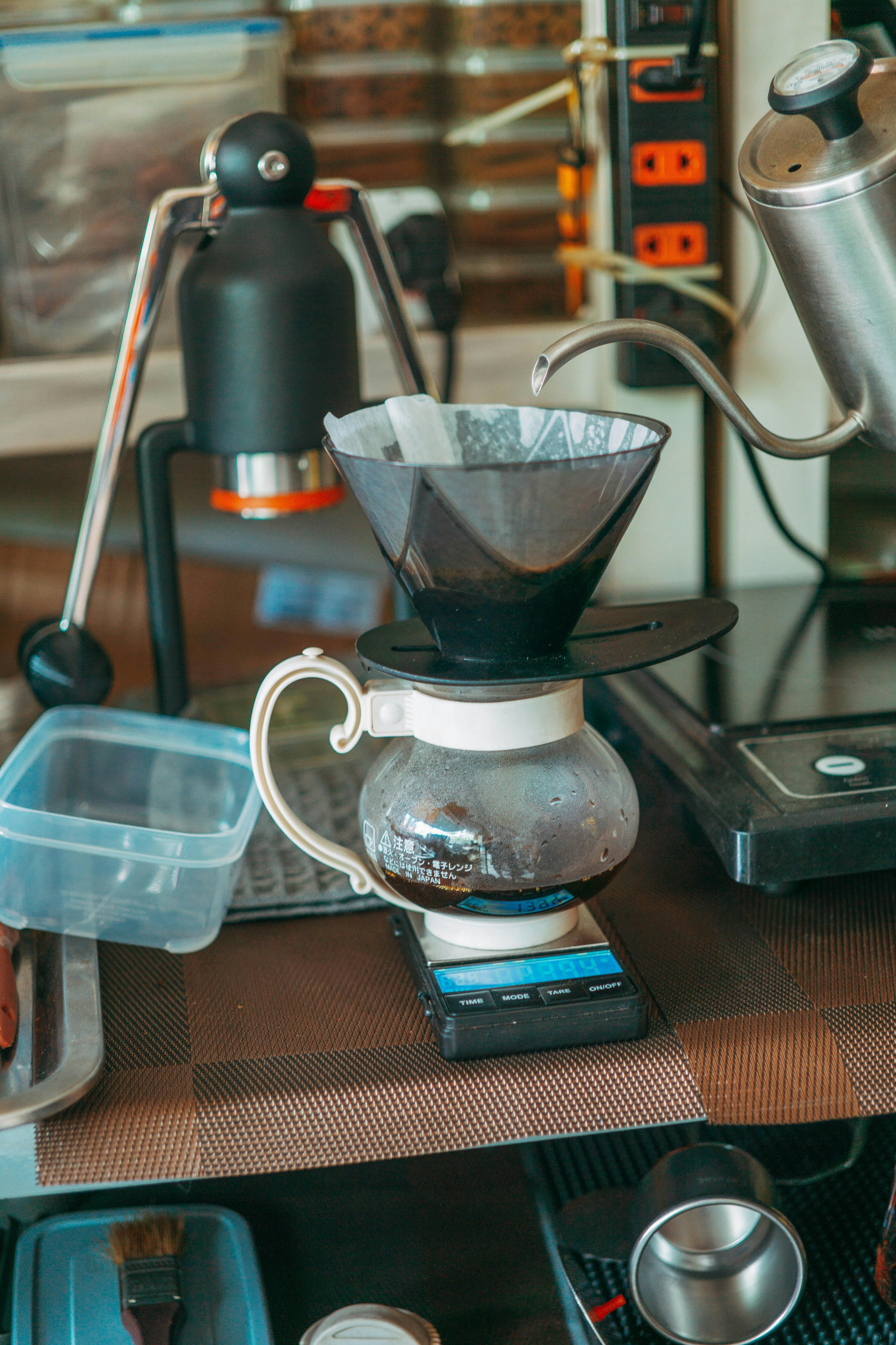 Pour-over dripper and kettle on a home coffee station